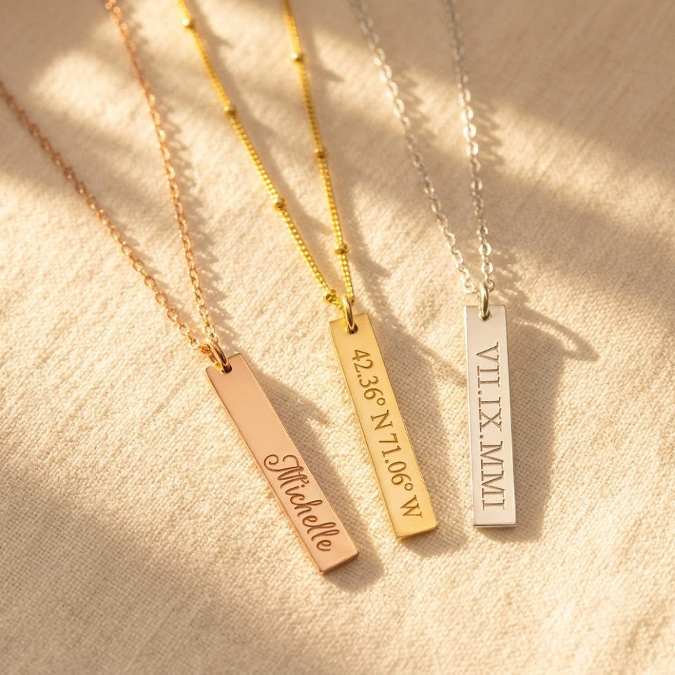 Personalized vertical bar necklaces in rose gold, yellow gold, and sterling silver with custom engraving