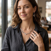 Woman wearing Silver Shifting Waves necklace and adjustable statement ring
