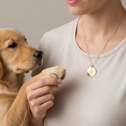 Personalized paw print necklace engraved with pet’s name, round disc pendant featuring a detailed paw print design in high polish gold vermeil, custom pet jewelry for dog or cat lovers, sentimental pet memorial necklace and everyday keepsake, handmade paw print charm on delicate gold chain, meaningful gift for pet moms and dads, loss of dog or cat remembrance jewelry, custom engraved pet necklace