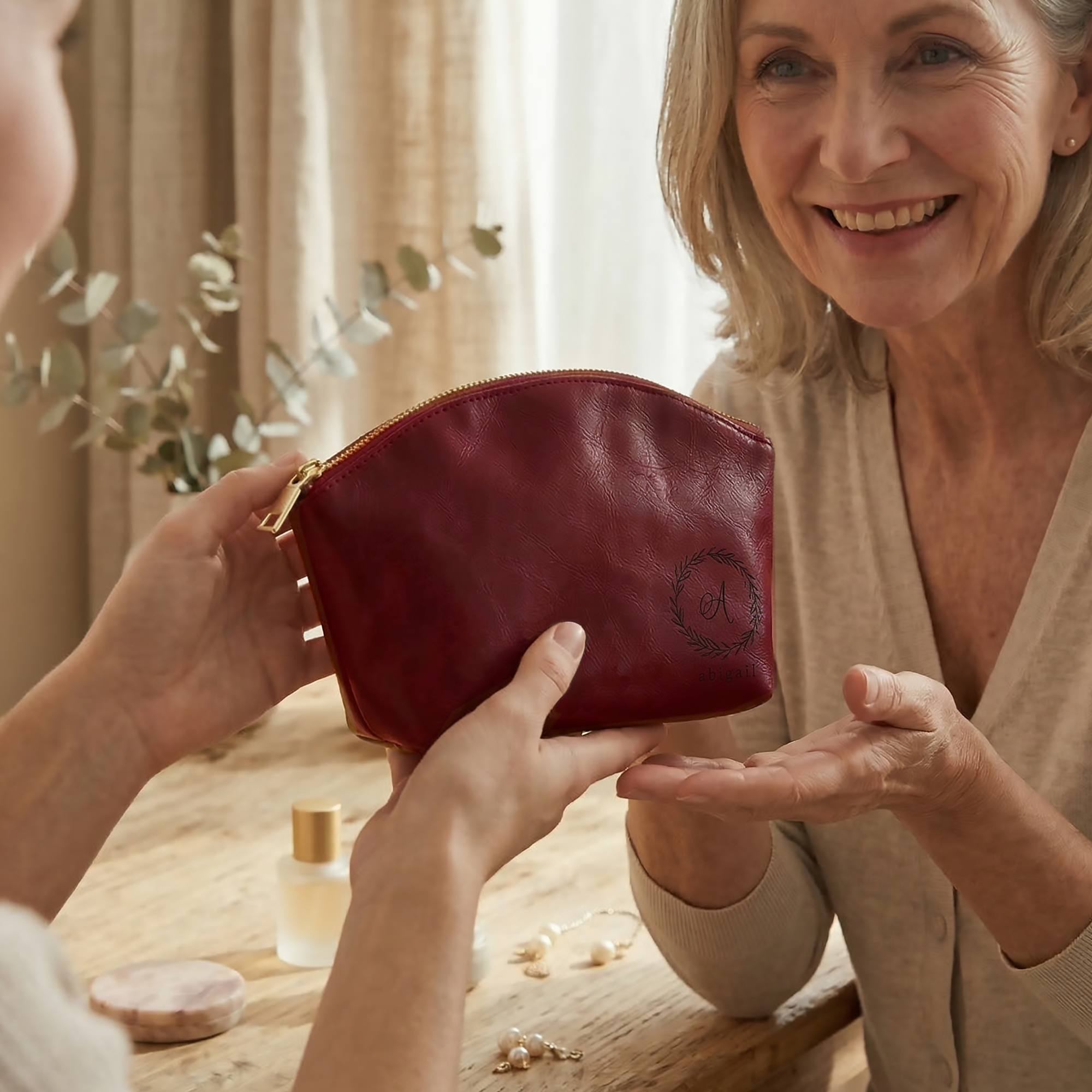 Close-up of a custom leather cosmetic bag featuring elegant monogram initials, crafted from durable leather with precise stitching and a sturdy zipper, perfect for organizing makeup, skincare items, and small beauty tools for everyday use or travel.