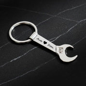 Single silver tone wrench keychain engraved with two names in script font. bottle opener keychain