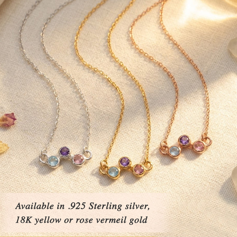 Custom birthstone necklace worn on model, featuring a delicate zigzag gemstone design for children’s birthstones or family stones shown in sterling silver or rose gold.