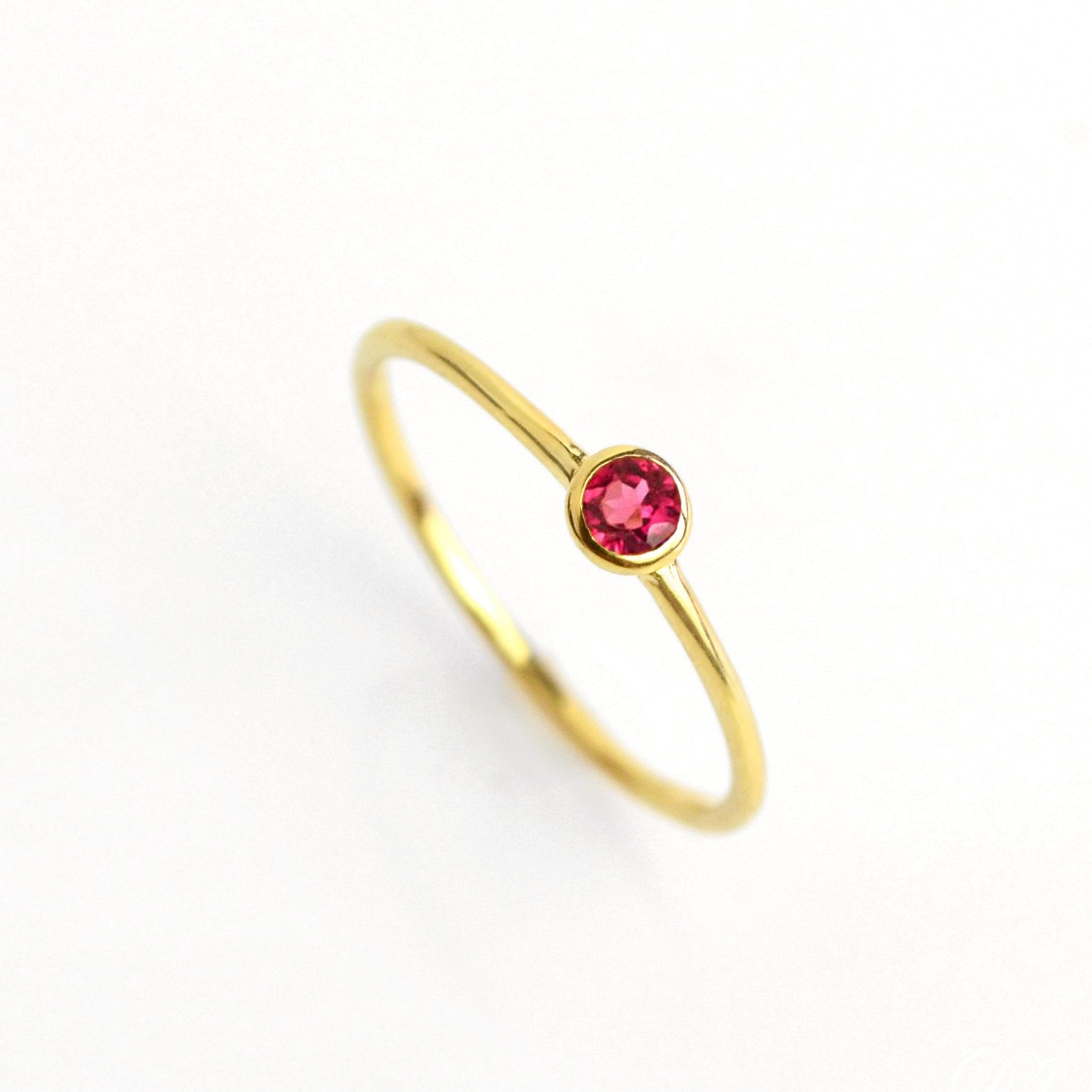 Single gold plated dainty 3mm Ruby gemstone ring. July  birthstone. On white background. 925 sterling silver, birthstone ring, stacking ring, stackable, birthstone jewelry, facet gemstone