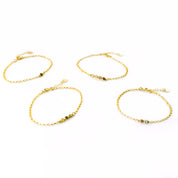 four gold anklet options featuring black onyx, peridot, pink chalcedony, garnet, iolite, ruby quartz and aqua chalcedony. 