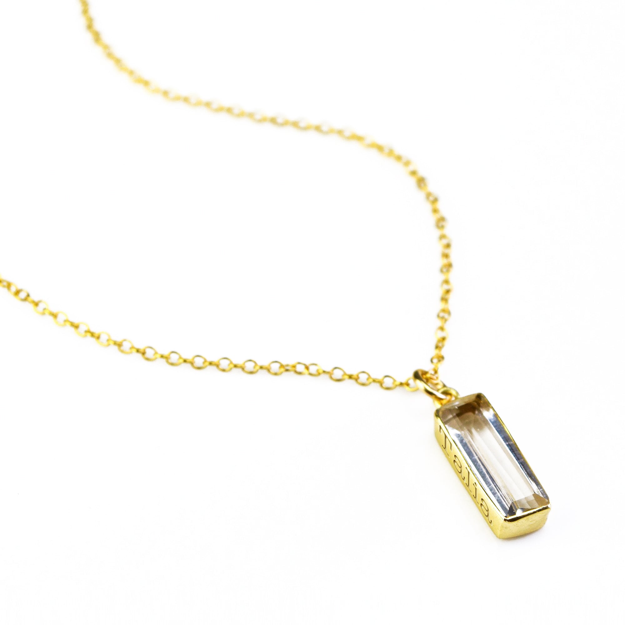 Gold filled single cable chain with vertical clear quartz april birthstone with secret engraving with classic font. 