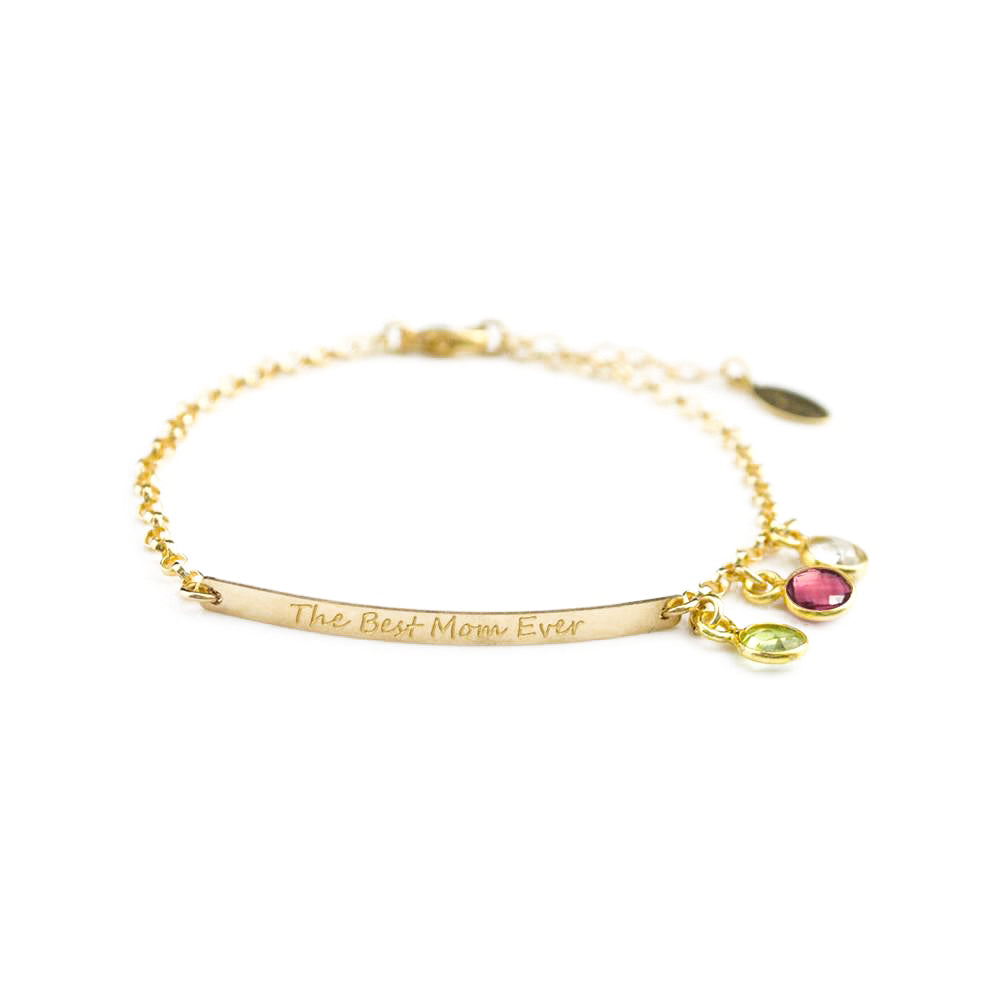 Gold filled dainty bar bracelet engraved with script font with the best mom ever quote and peridot, ruby, and clear birthstones