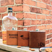 Three custom engraved leather flasks in honey with name and message, cinnamon for the college graduate and espresso with monogram.