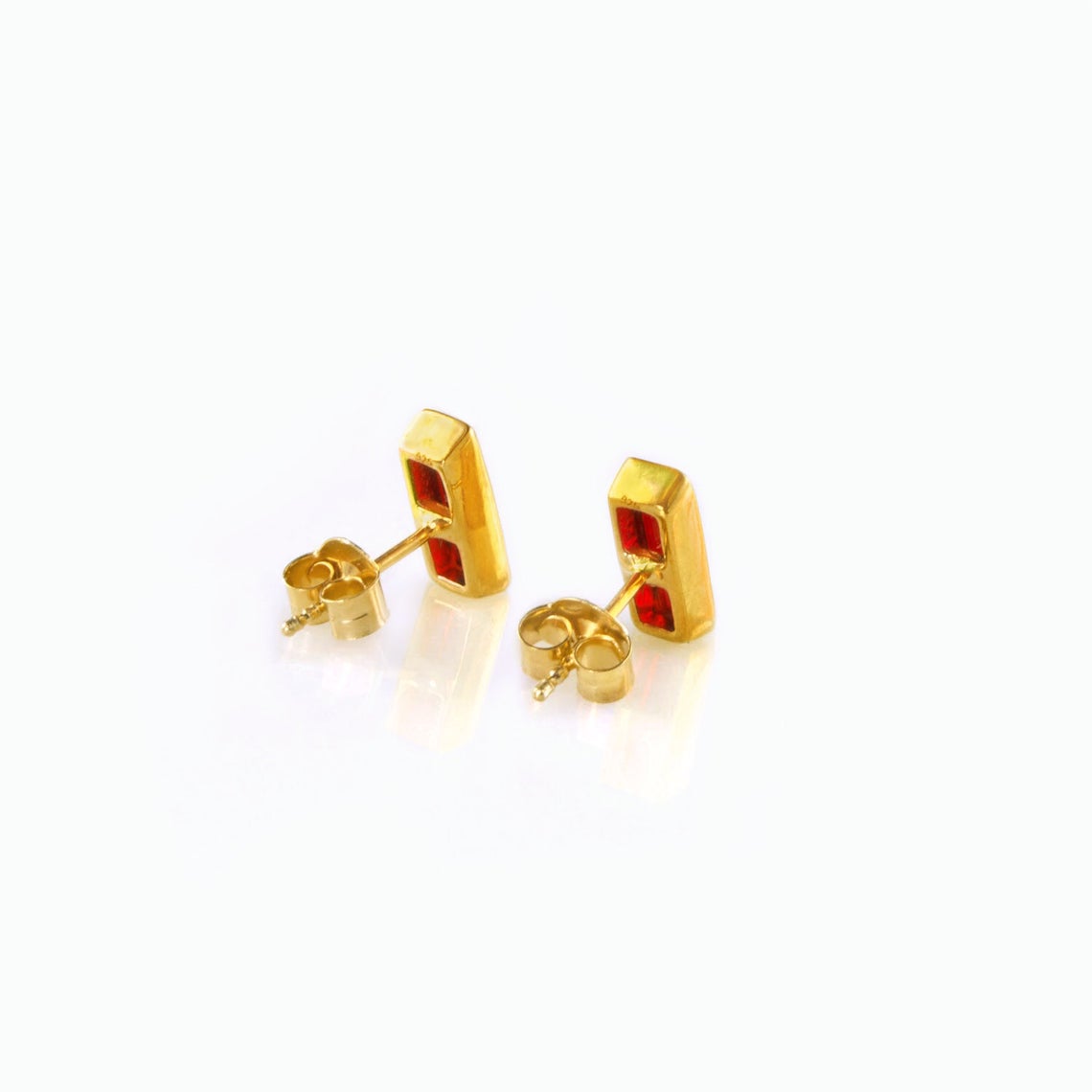 Red garnet baguette birthstone stud earrings on white background
