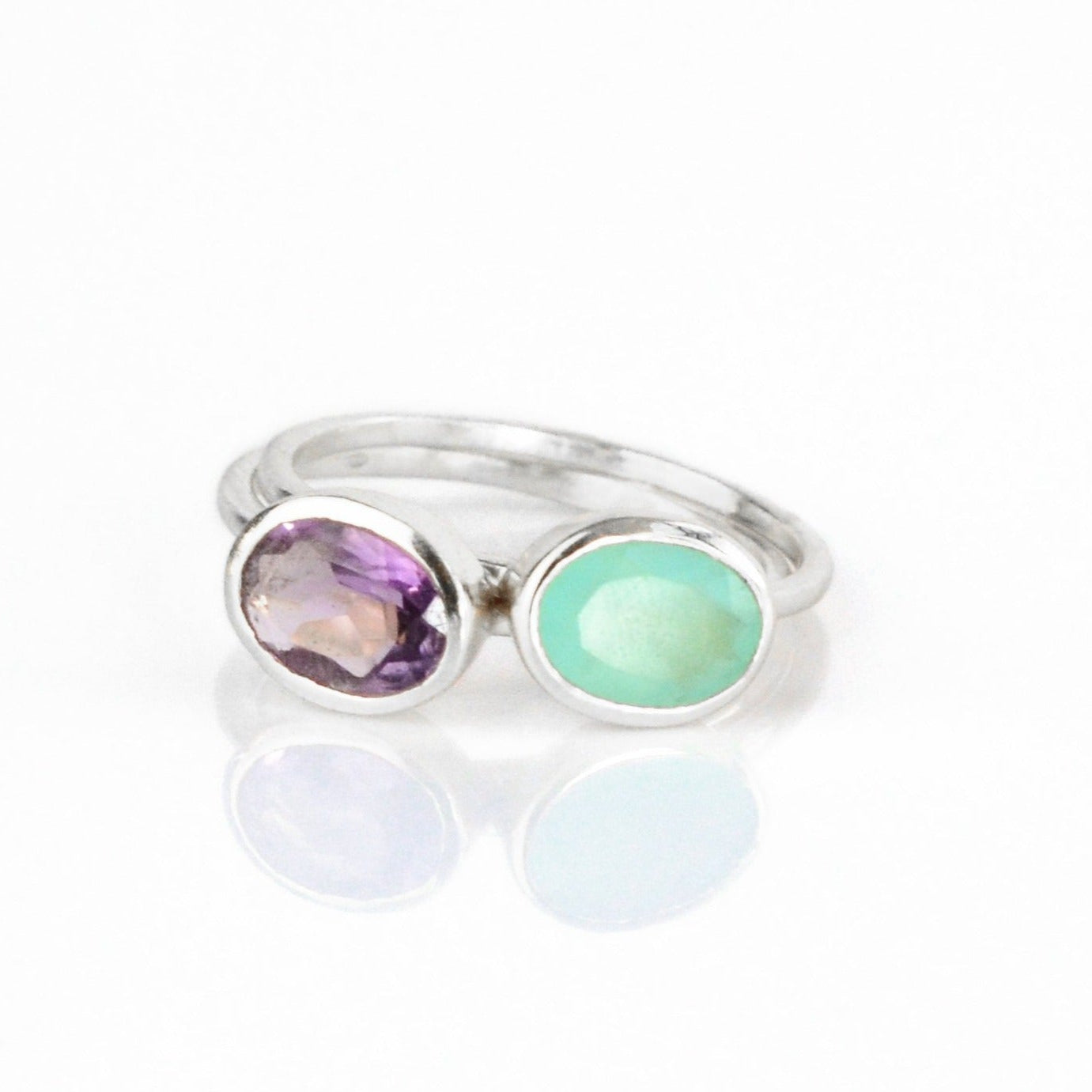 Stackable oval gemstone birthstone ring featuring amethyst for February and March aqua chalcedony as a modern alternative. Sterling silver setting makes a dainty, customizable jewelry gift.