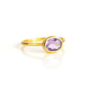 Gold plated purple amethyst ring on white background. purple gemstone, purple birthstone, february birthstone, february gemstone, stack set, stacking rings, gemstone ring, birthstone ring, mother's day gift for her, gift for mom, gift for fiance, gift for girlfriend, wedding jewelry, bridesmaid jewelry, anniversary jewelry, anniversary gift, birthday gift, christmas gift, valentine's day gift, valentine's day rings, dainty ring, cocktail ring, statement ring, bezel set, dainty ring, oval ring