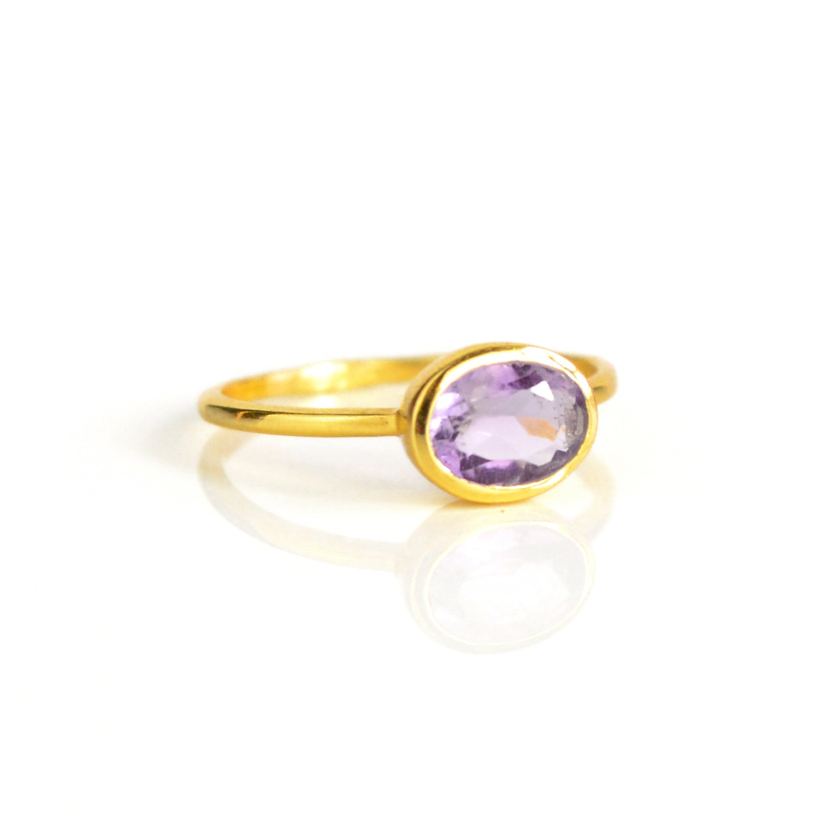 Gold plated purple amethyst ring on white background. purple gemstone, purple birthstone, february birthstone, february gemstone, stack set, stacking rings, gemstone ring, birthstone ring, mother's day gift for her, gift for mom, gift for fiance, gift for girlfriend, wedding jewelry, bridesmaid jewelry, anniversary jewelry, anniversary gift, birthday gift, christmas gift, valentine's day gift, valentine's day rings, dainty ring, cocktail ring, statement ring, bezel set, dainty ring, oval ring
