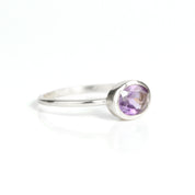 a sterling silver purple amethyst ring shown on white background. stackable! Stacking rings, bezel set, small oval, tiny oval, dainty oval, birthstone rings, sterling silver stamp, birthstone ring, birthstone jewelry, purple gemstone, purple birthstone, february birthstone, february gemstone, purple gemstone, purple birthstone, february birthstone, february gemstone, stack set, stacking rings, gemstone ring, birthstone ring, mother's day gift for her, gift for mom, gift for fiance, gift for girlfriend