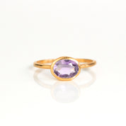a rose gold purple amethyst ring shown on white background. stackable! Stacking rings, bezel set, small oval, tiny oval, dainty oval, birthstone rings, sterling silver stamp, birthstone ring, birthstone jewelry, purple gemstone, purple birthstone, february birthstone, february gemstone, purple gemstone, purple birthstone, february birthstone, february gemstone, stack set, stacking rings, gemstone ring, birthstone ring, mother's day gift for her, gift for mom, gift for fiance, gift for girlfriend