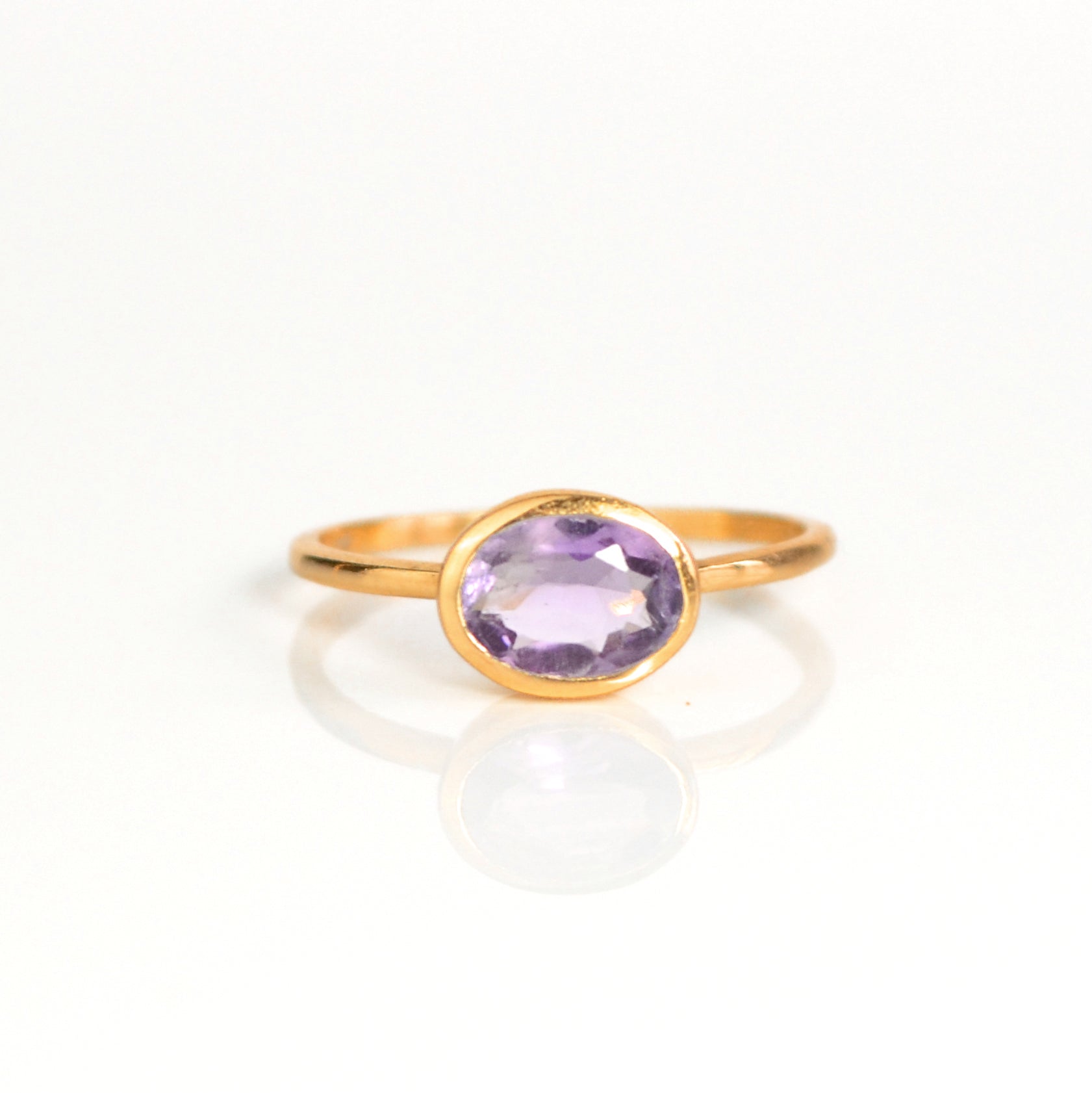 a rose gold purple amethyst ring shown on white background. stackable! Stacking rings, bezel set, small oval, tiny oval, dainty oval, birthstone rings, sterling silver stamp, birthstone ring, birthstone jewelry, purple gemstone, purple birthstone, february birthstone, february gemstone, purple gemstone, purple birthstone, february birthstone, february gemstone, stack set, stacking rings, gemstone ring, birthstone ring, mother's day gift for her, gift for mom, gift for fiance, gift for girlfriend