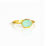 a gold aqua chalcedony ring shown on white background. Stacking rings, bezel set, small oval, tiny oval, dainty oval, birthstone rings, sterling silver stamp, birthstone ring, birthstone jewelry, march birthstone, march gemstone, stack set, stacking rings, gemstone ring, birthstone ring, mother's day gift for her, gift for mom, gift for fiance, gift for girlfriend, wedding jewelry, bridesmaid jewelry, anniversary jewelry, anniversary gift, birthday gift, christmas gift, valentine's day gift