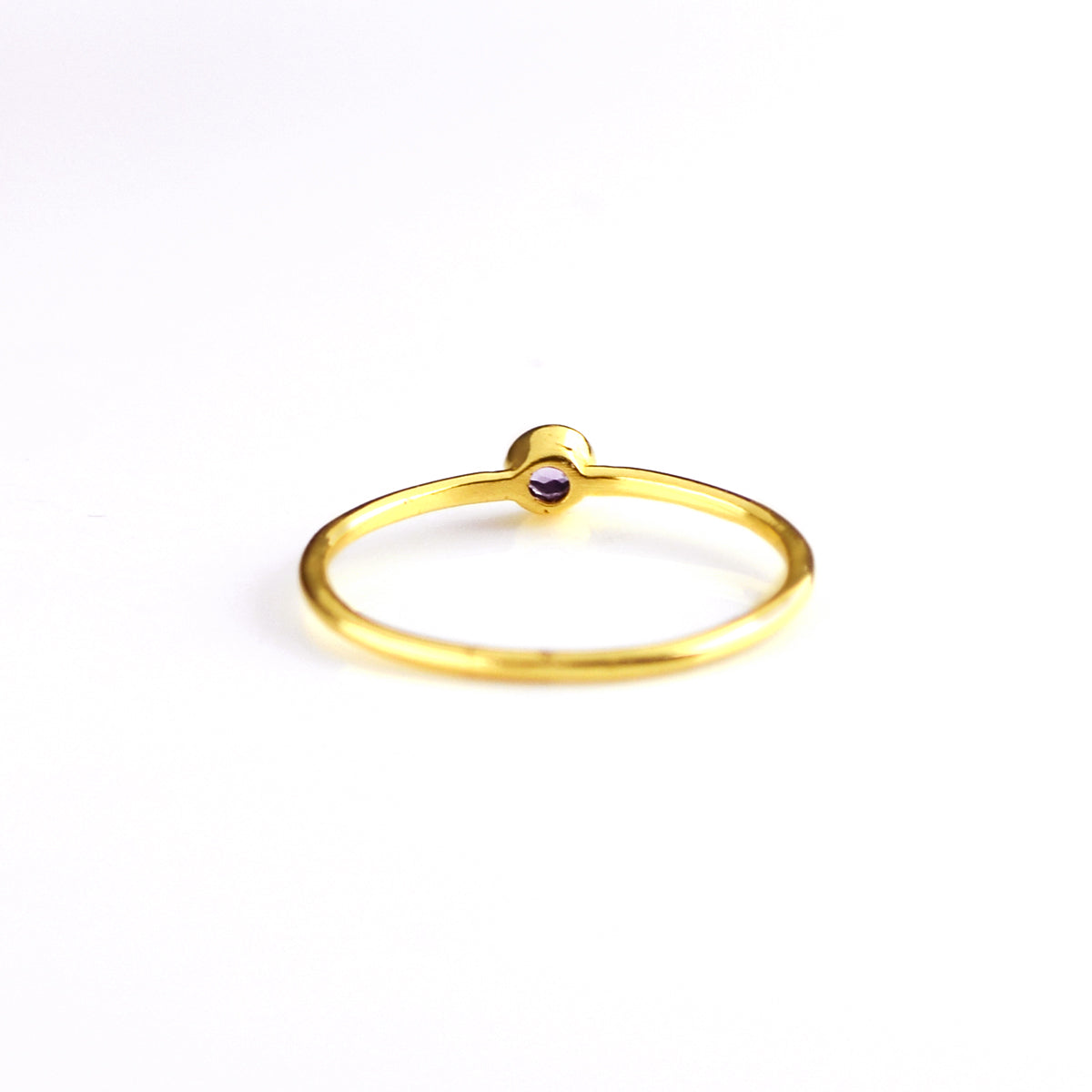 Back of the dainty 3mm stacking gold plated birthstone ring on a white background. 