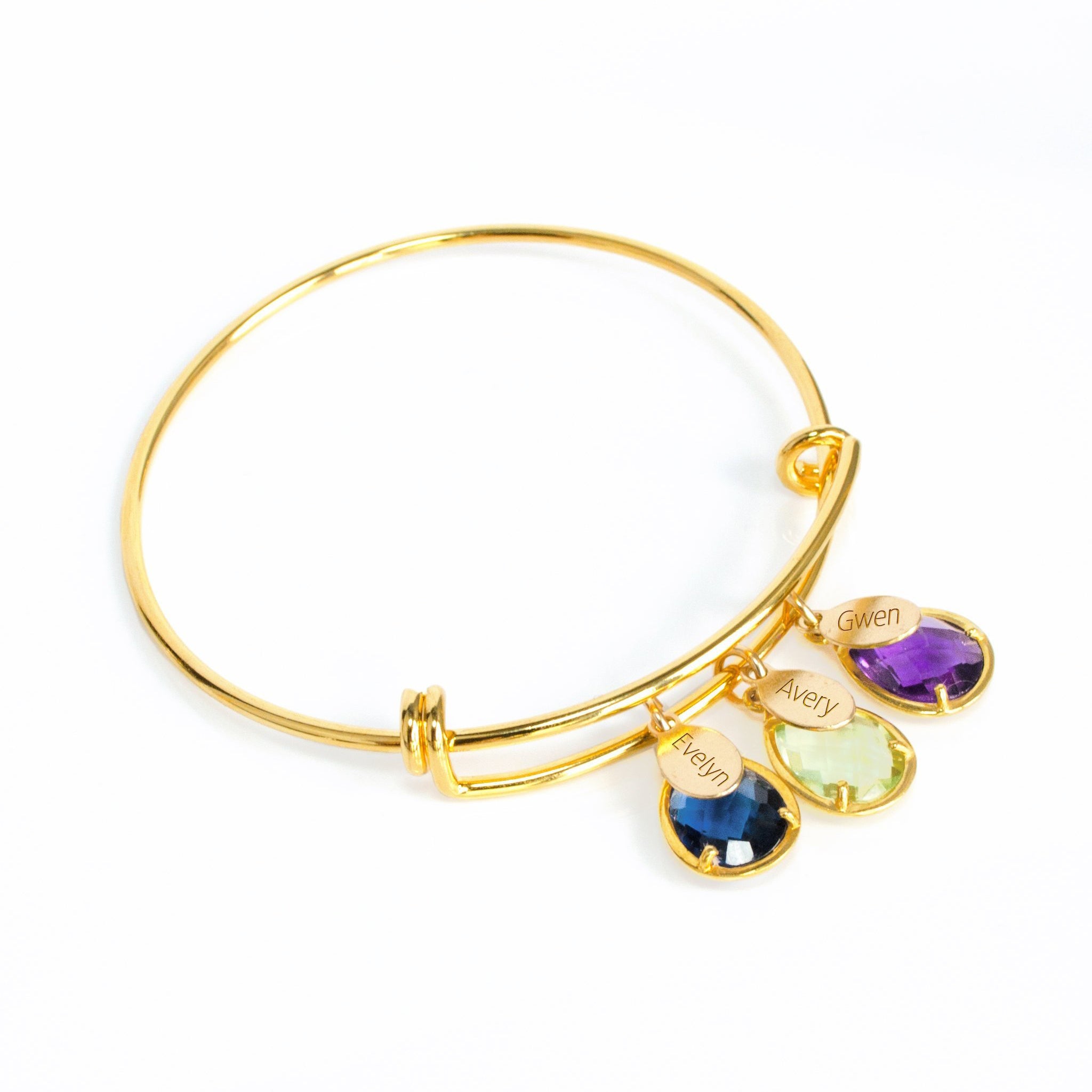 Gold bangle on top with full classic names engraved with kyanite, peridot and purple amethyst birthstones.