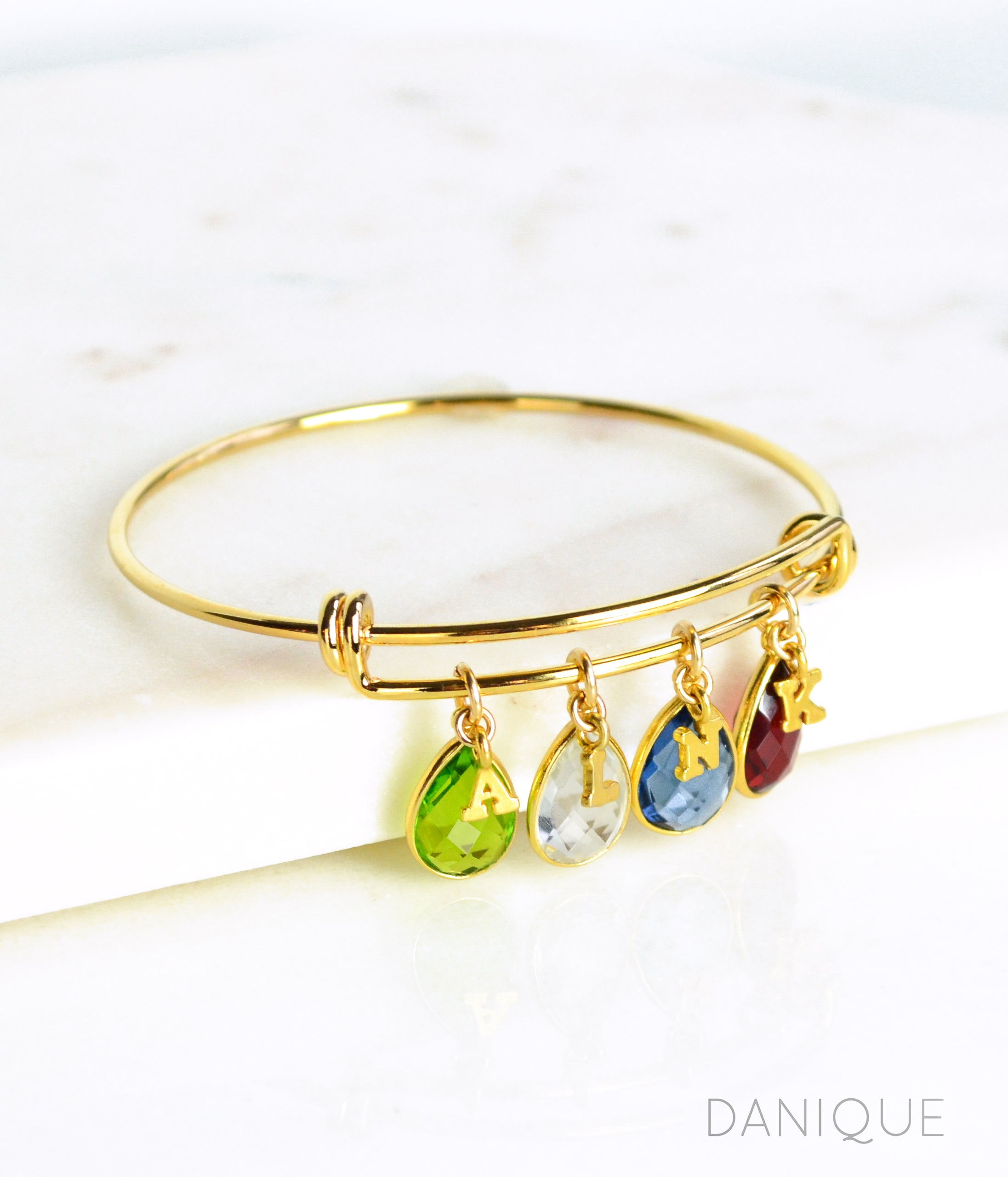 Bangle with Birthstones and Initial Charms Yellow Gold 4 Birthstones and 4 Initial Charms Peridot Clear Quartz Kyanite Garnet Gemstones