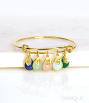 Single gold bangle bracelet with stamped leaf charms and lapis, aqua chalcedony, piny chalcedony, opalite and green onyx birthstones.