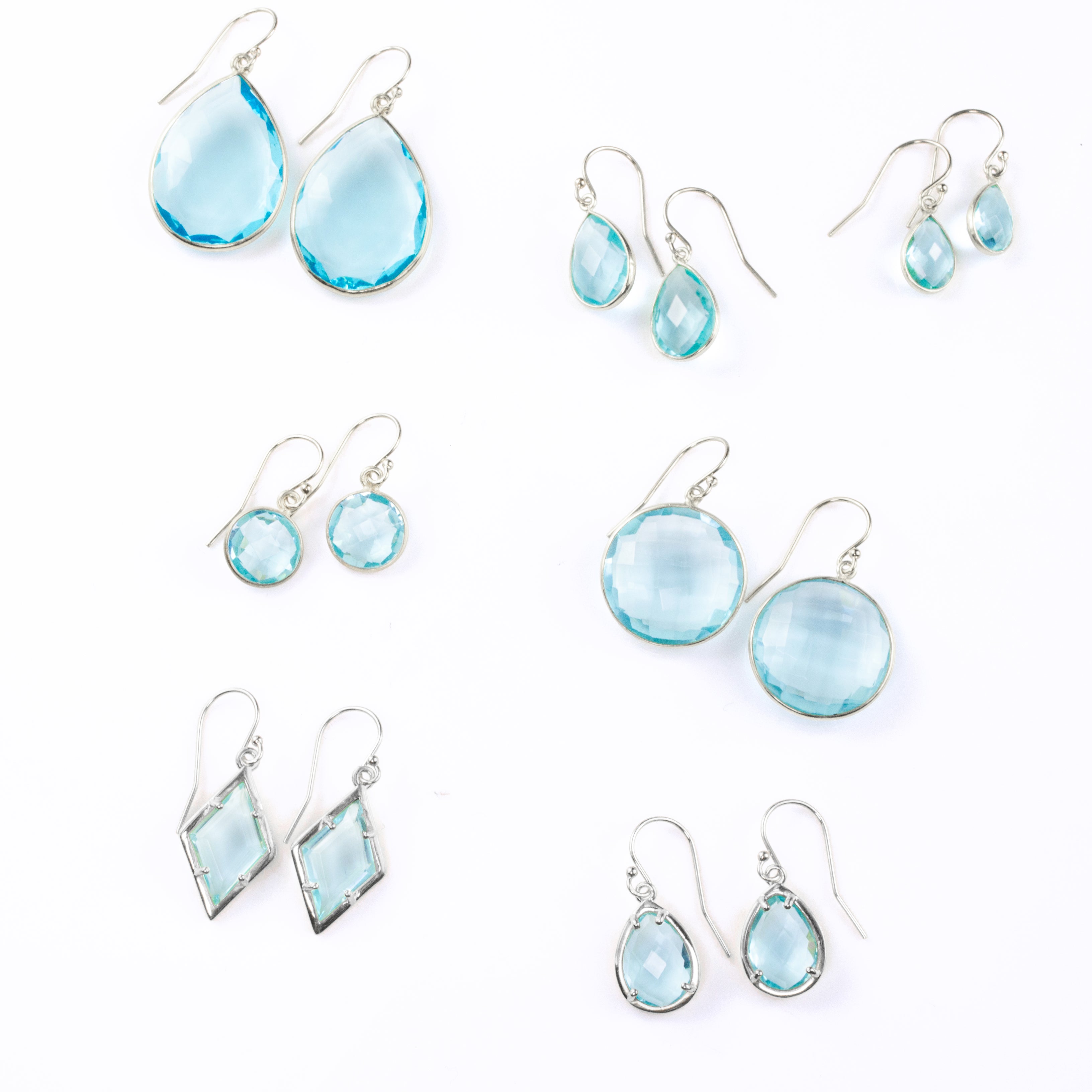 Shop our blue topaz earrings collection available in large, medium and small teardrops, prong set teardrop, prong set diamond, large and medium rounds on white background december birthstone