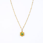 Large gold filled floral flower bloom necklace with satellite chain and green onyx birthstone on a white background. 