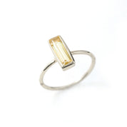 Sterling Silver tiny gemstone adira bar ring with citrine birthstone on white background. 