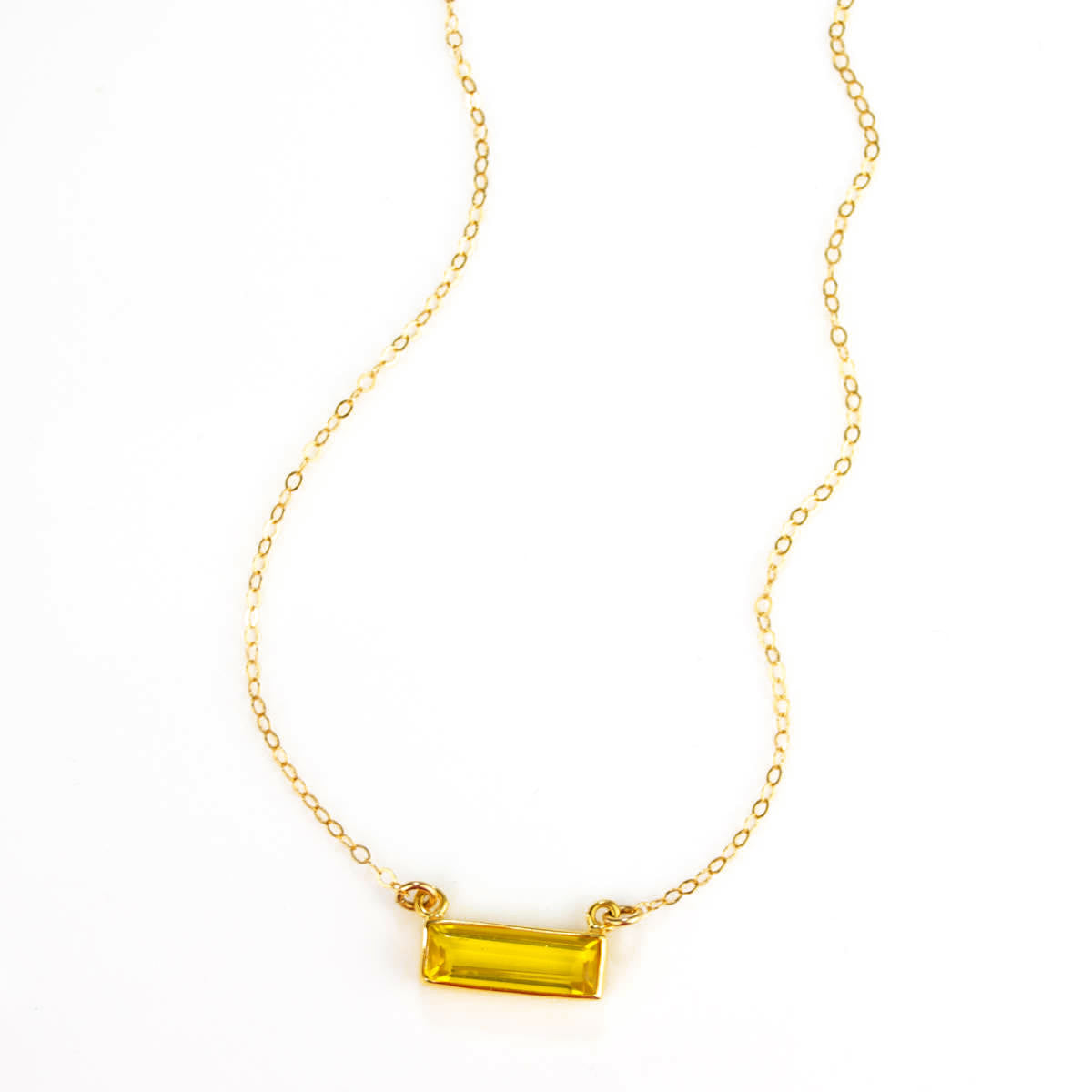 Single gold filled cable chain horizontal citrine november birthstone bar necklace on white background. 