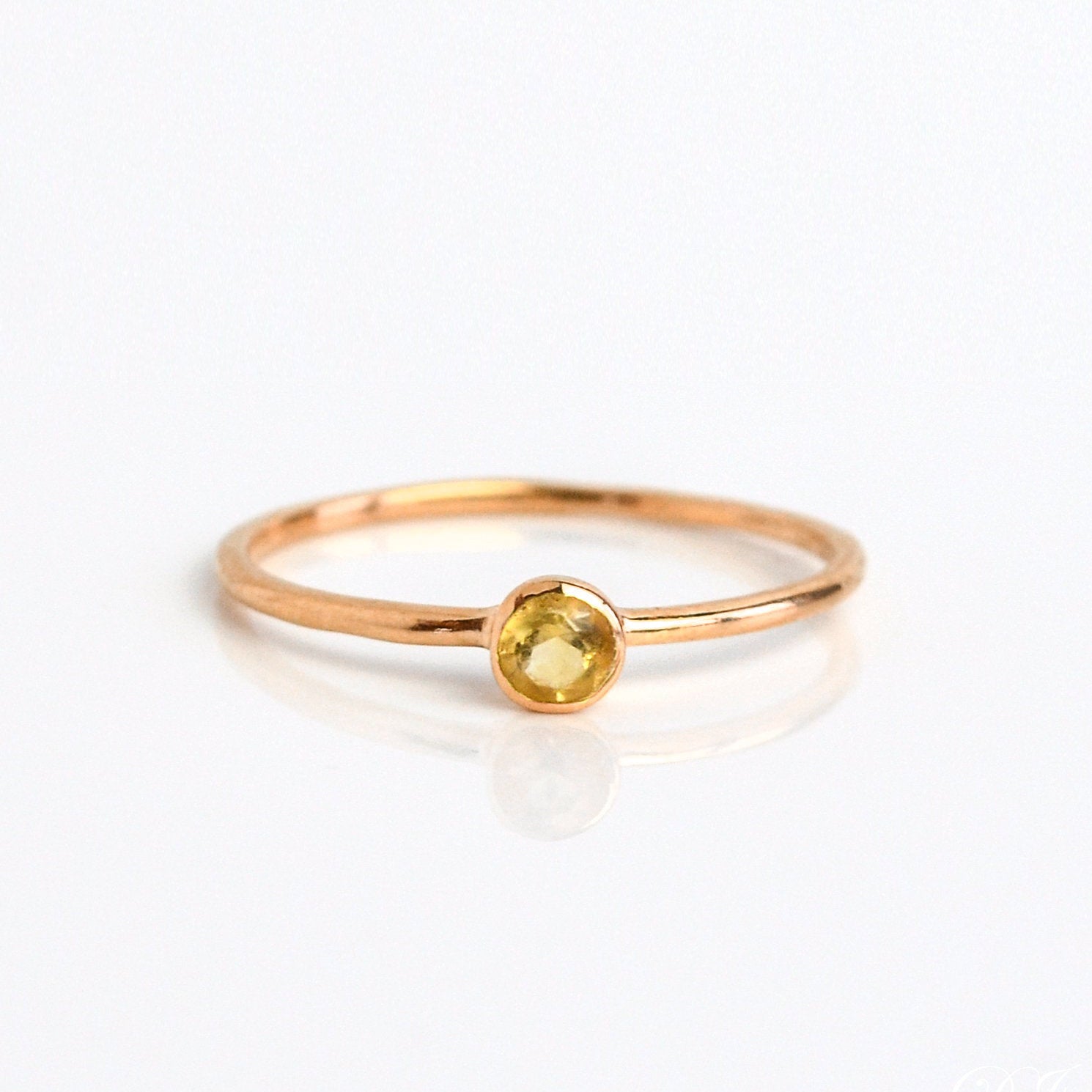 Rose gold plated citrine gemstone ring. dainty 3mm citrine gemstone ring. November birthstone. On white background. 