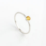 Sterling silver dainty 3mm citrine gemstone ring. November birthstone. On white background. 