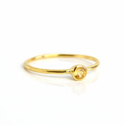 Single gold plated 3mm dainty stacking citrine ring. Birthstone ring. November birthstone. On a white background. 