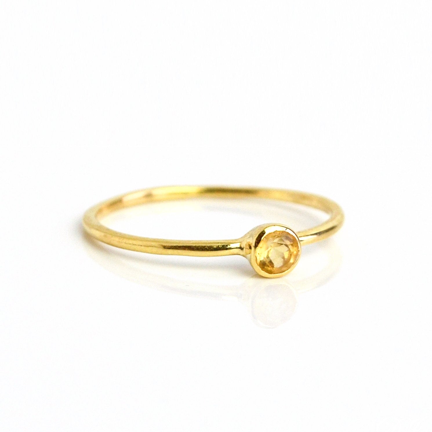 Single gold plated 3mm dainty stacking citrine ring. Birthstone ring. November birthstone. On a white background. 