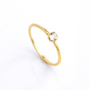 Single gold plated dainty 3mm clear quartz gemstone ring. april  birthstone. On white background. 925 sterling silver, birthstone ring, stacking ring, stackable, birthstone jewelry, facet gemstone
