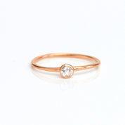 Single Rose gold plated dainty 3mm clear quartz gemstone ring. april  birthstone. On white background. 925 sterling silver, birthstone ring, stacking ring, stackable, birthstone jewelry, facet gemstone