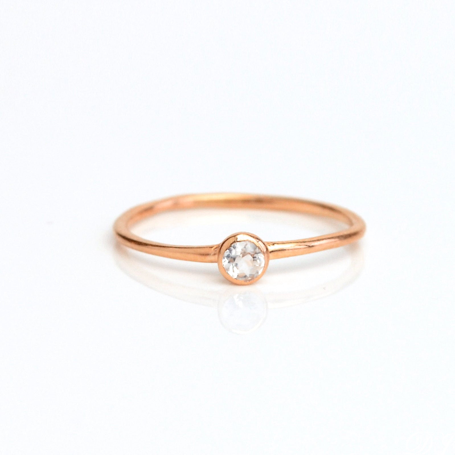 Single Rose gold plated dainty 3mm clear quartz gemstone ring. april  birthstone. On white background. 925 sterling silver, birthstone ring, stacking ring, stackable, birthstone jewelry, facet gemstone