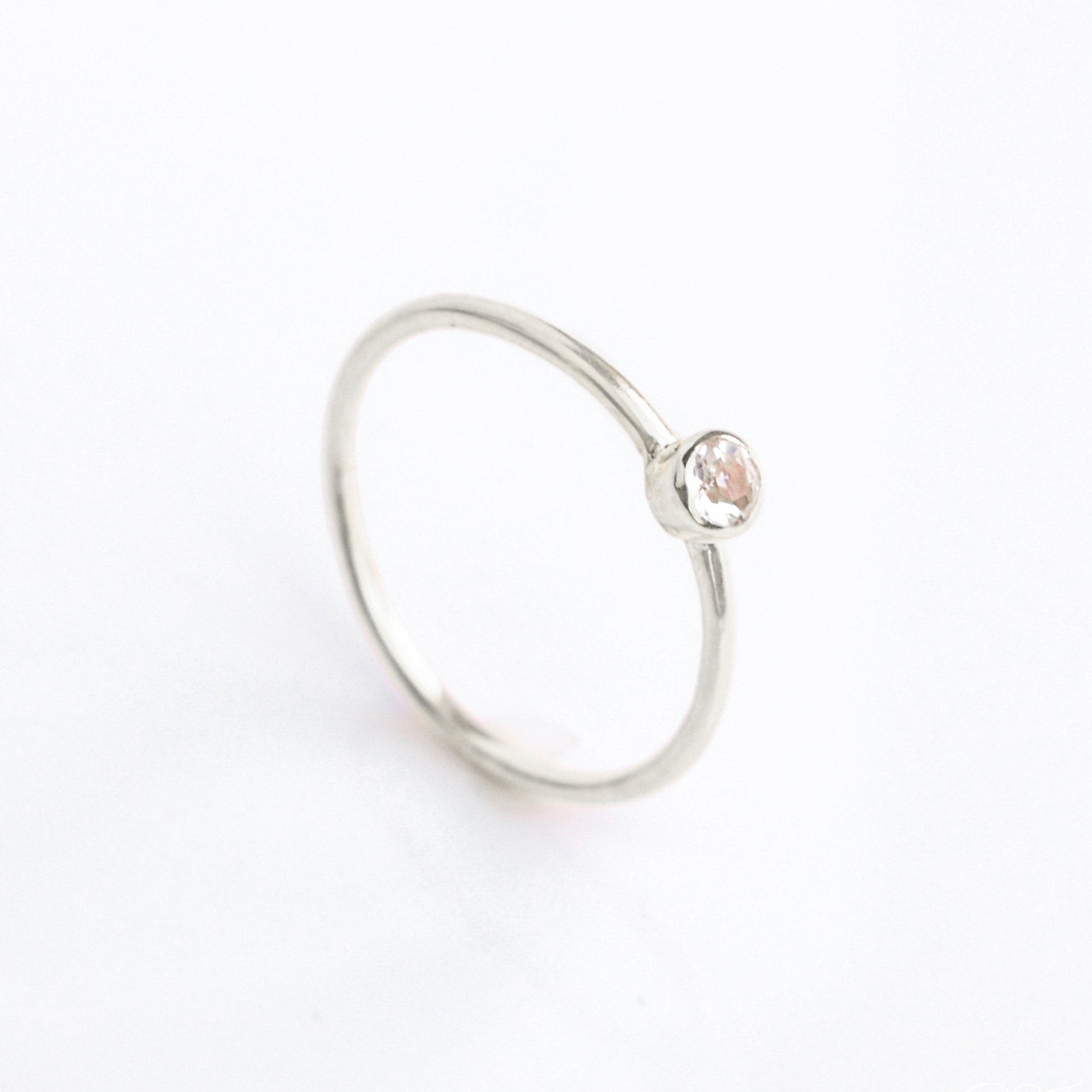Sterling silver Single dainty 3mm clear quartz gemstone ring. april  birthstone. On white background. 925 sterling silver, birthstone ring, stacking ring, stackable, birthstone jewelry, facet gemstone