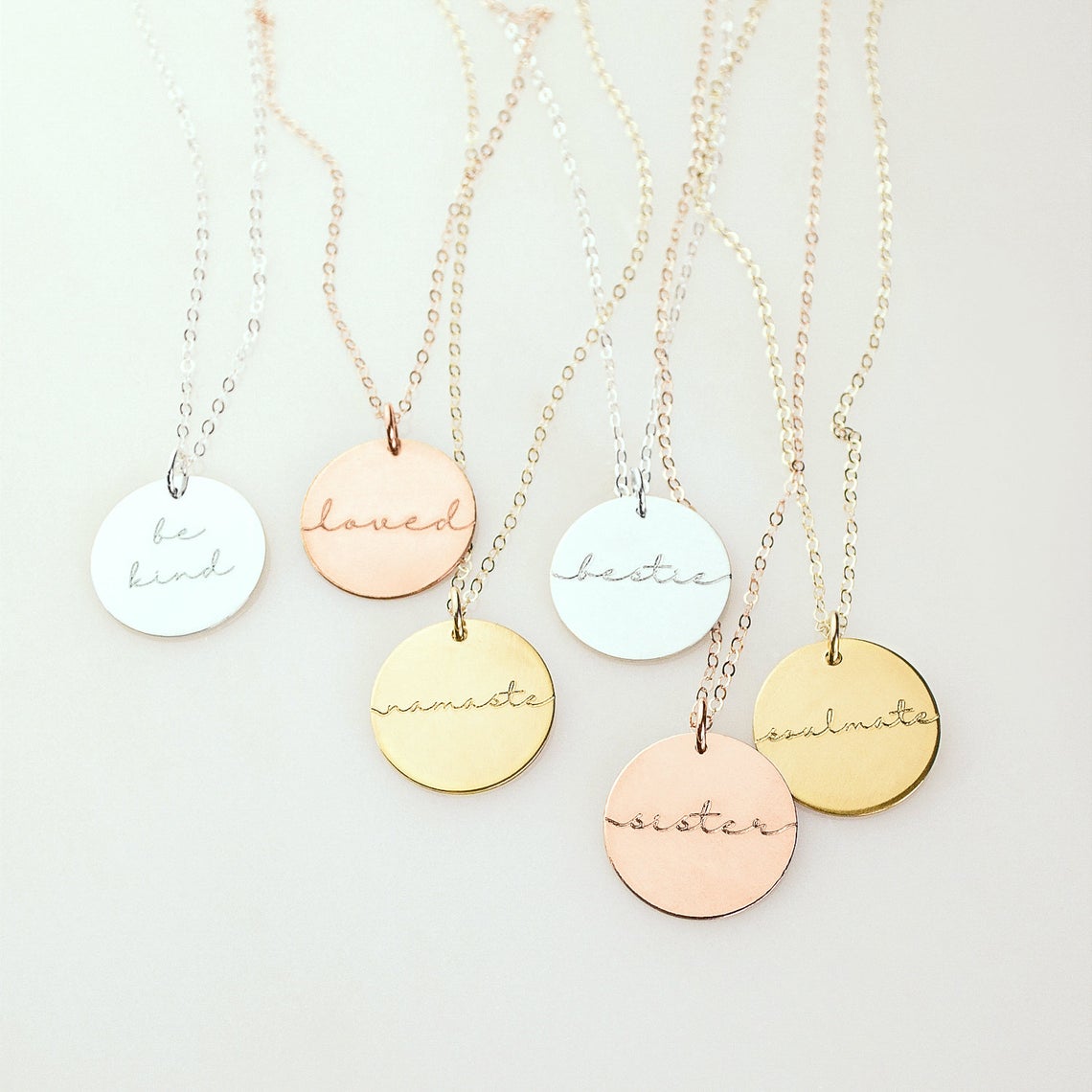 Mama 19mm disc necklaces come in rose gold filled, sterling silver or gold filled. Necklaces from left to right are sterling silver, rose gold plated, gold plated, sterling silver, rose gold plated, gold plated. 