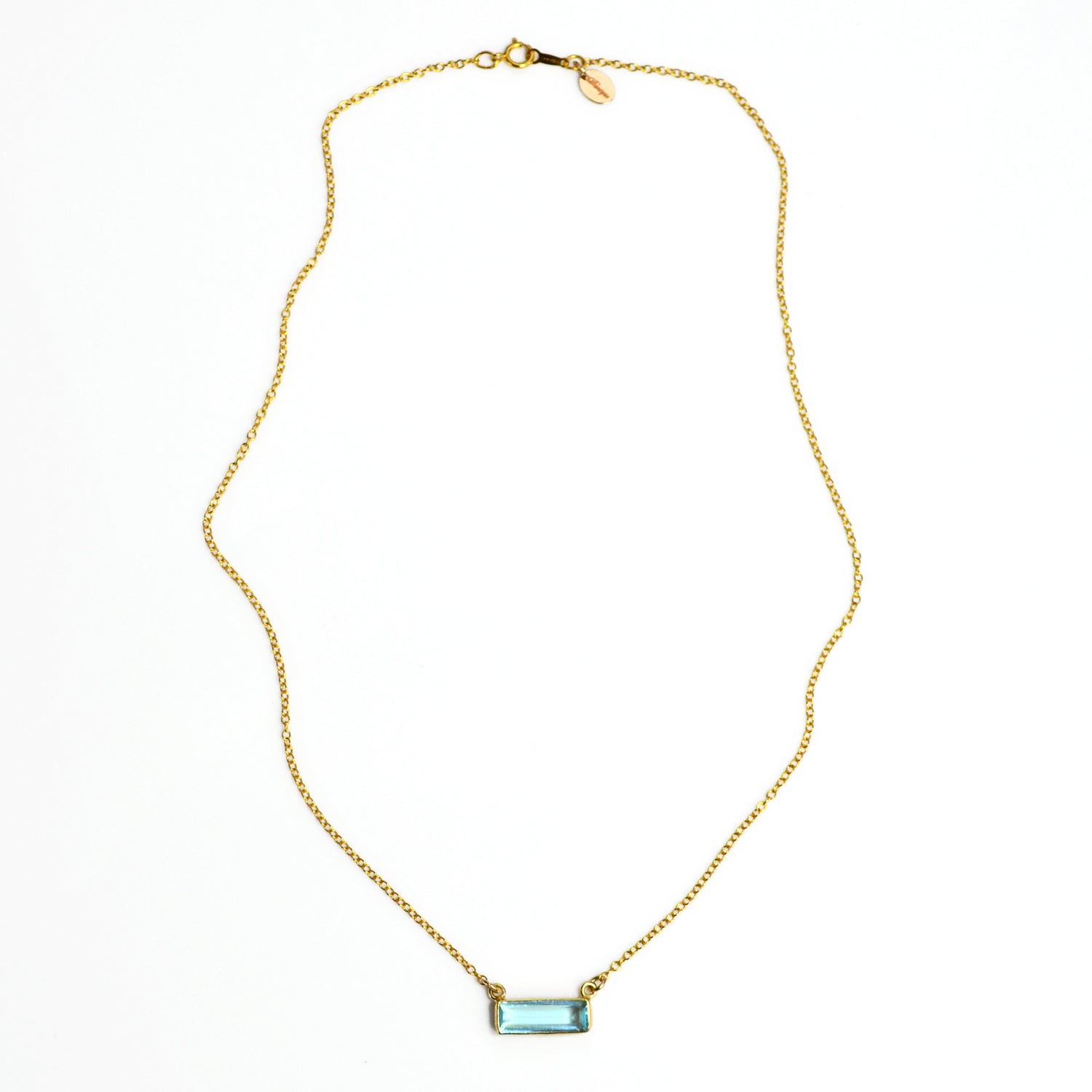 Single gold filled cable chain with horizontal blue topaz december birthstone adira bar necklace with secret message engraved on the top in typewriter font on white background