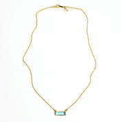 Single gold filled cable chain with horizontal blue topaz december birthstone adira bar necklace with secret message engraved on the top in typewriter font on white background