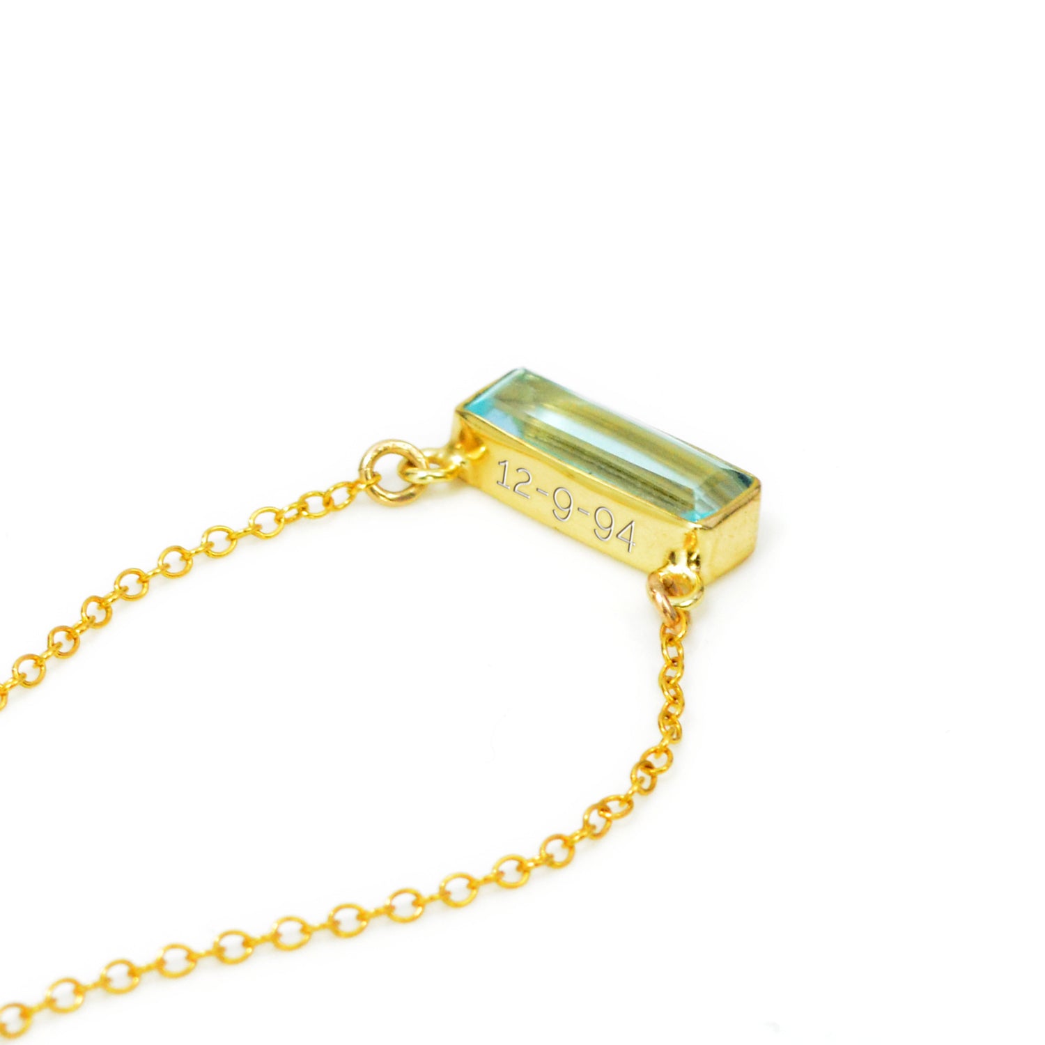 Single gold filled cable chain with horizontal blue topaz december birthstone adira bar necklace with secret message engraved on the top in typewriter font on white background