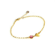 Gold filled double leaf charm with initial engraved and ruby birthstone on a white background. Ruby gemstone charm name