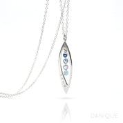 Sterling silver mothers family tree necklace with open leaf pendant featuring kyanite, blue topaz, moonstone and aqua chalcedony birthstones with initials engraved on white background
