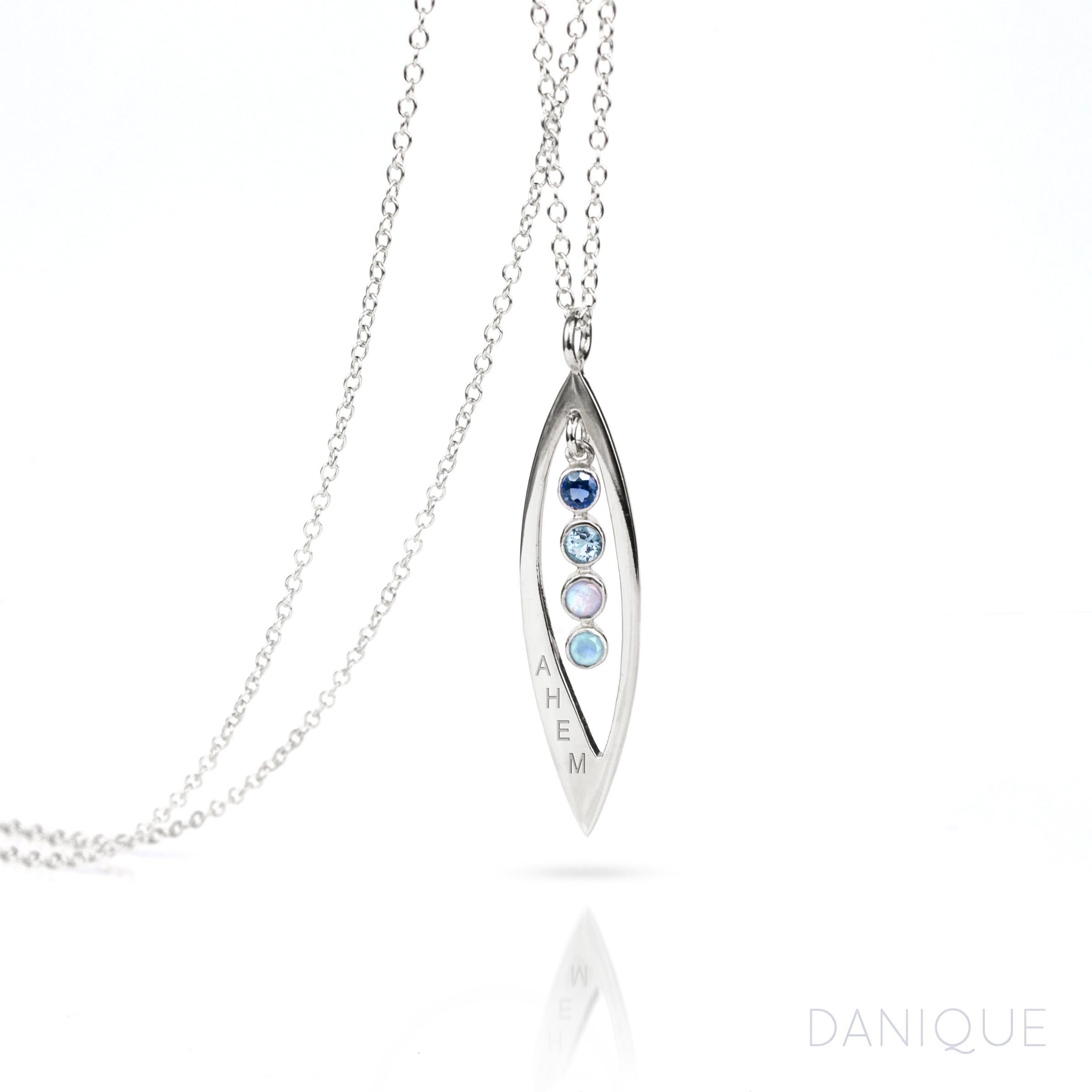 Sterling silver mothers family tree necklace with open leaf pendant featuring kyanite, blue topaz, moonstone and aqua chalcedony birthstones with initials engraved on white background