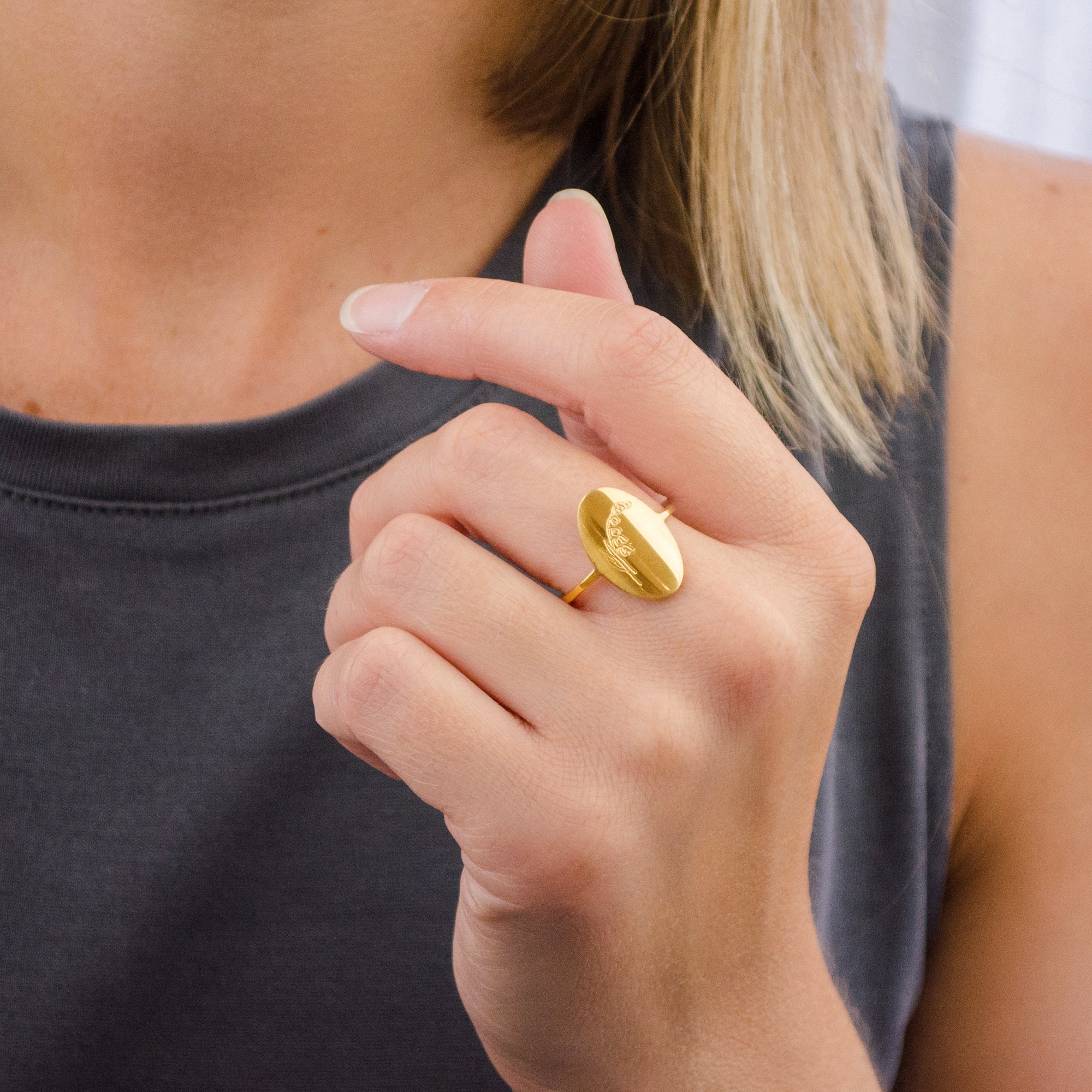 Model wears single gold flower engraved ring