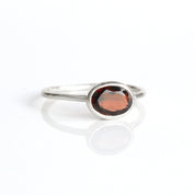 a sterling silver garnet ring shown on white background. stackable! stack set, stacking rings, gemstone ring, birthstone ring, mother's day gift for her, gift for mom, gift for fiance, gift for girlfriend, wedding jewelry, bridesmaid jewelry, anniversary jewelry, anniversary gift, birthday gift, christmas gift, valentine's day gift, valentine's day rings, dainty ring, cocktail ring, statement ring, bezel set, birthstone jewelry, birthstone ring