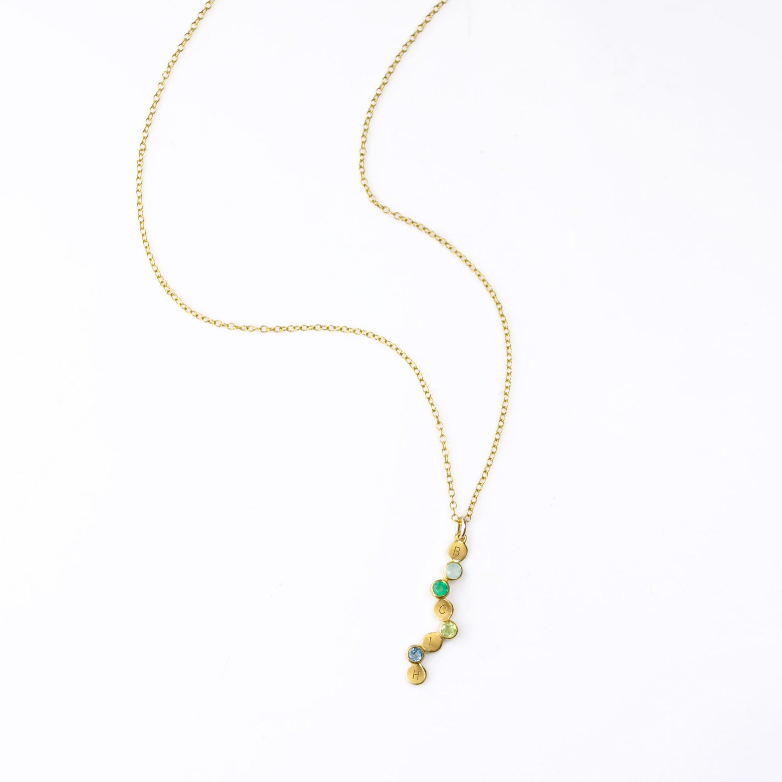 goldverticalpendantnecklacebirthstonesandengravedinitials.jpg