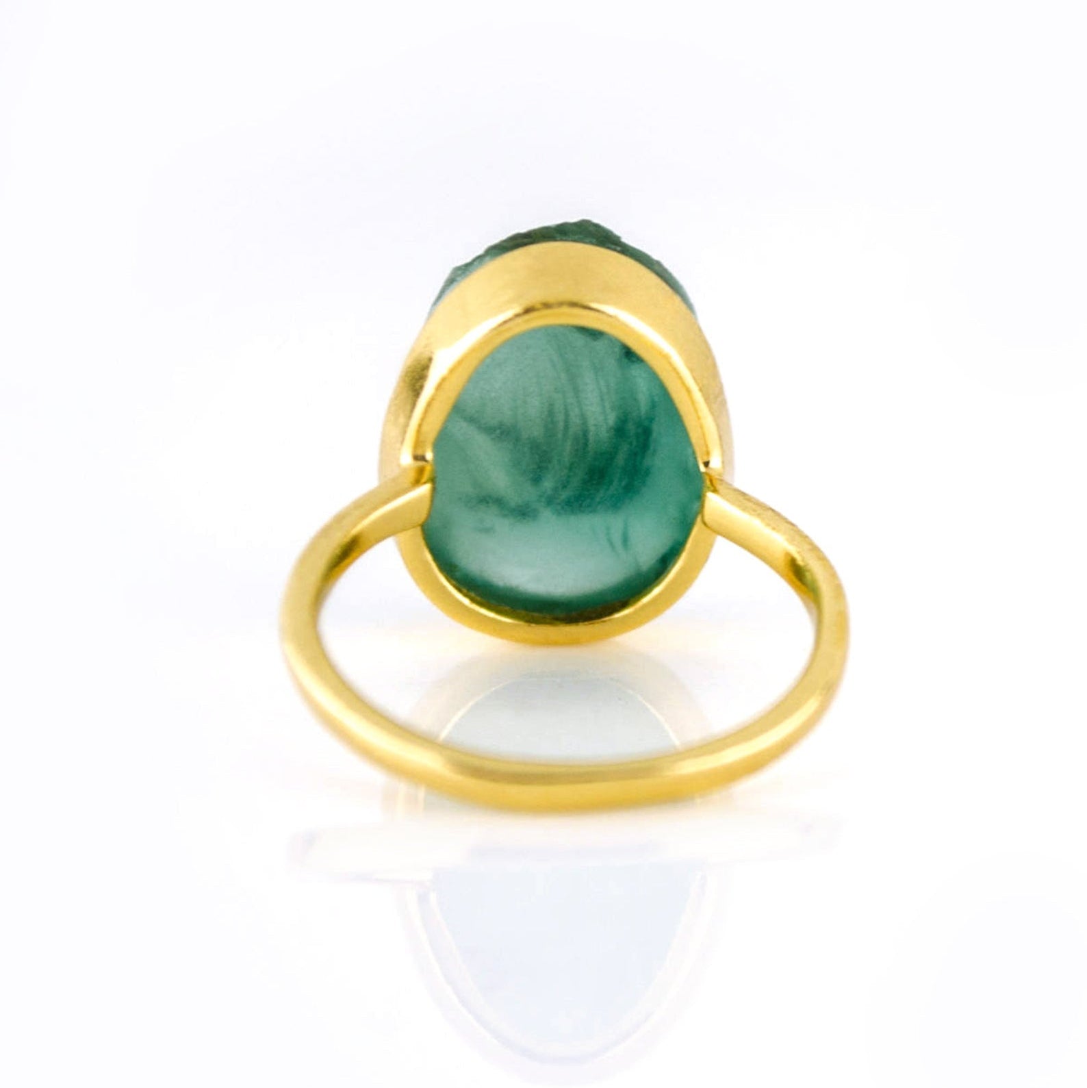 Back view of a gold rough green tourmaline ring showing the band and gemstone setting.