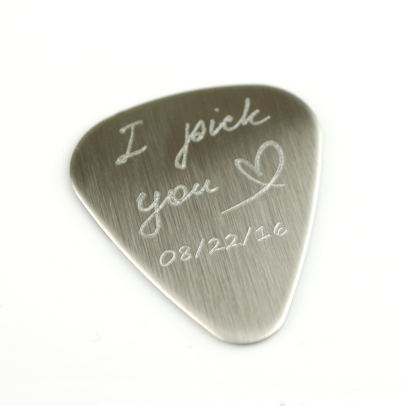 Guitar pick engraved with the I pick you design with a heart and date on white background