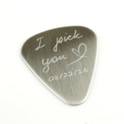 Guitar pick engraved with the I pick you design with a heart and date on white background