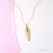 Gold filled mothers family tree necklace with open leaf pendant featuring garnet, ruby, pink chalcedony, aqua chalcedony and clear birthstones with mama engraving on white background