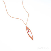 Rose gold filled mothers family tree necklace with open leaf pendant featuring purple amethyst and garnet birthstones with initial engraving on white background